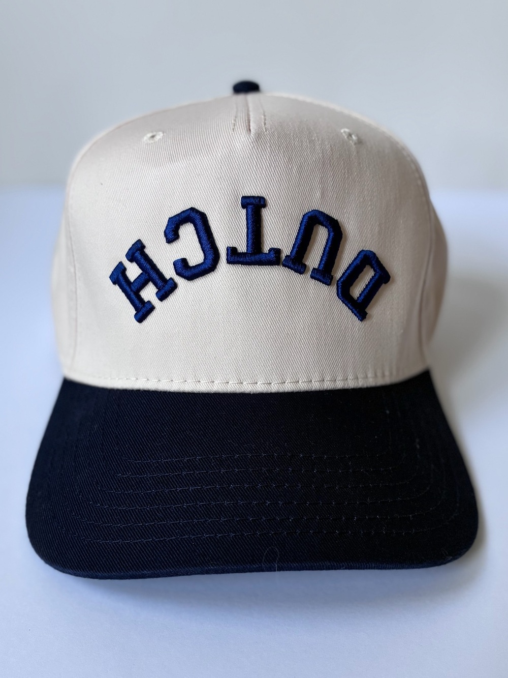 Dutch Bros Upside Down SnapBack Hat- Cream & Navy